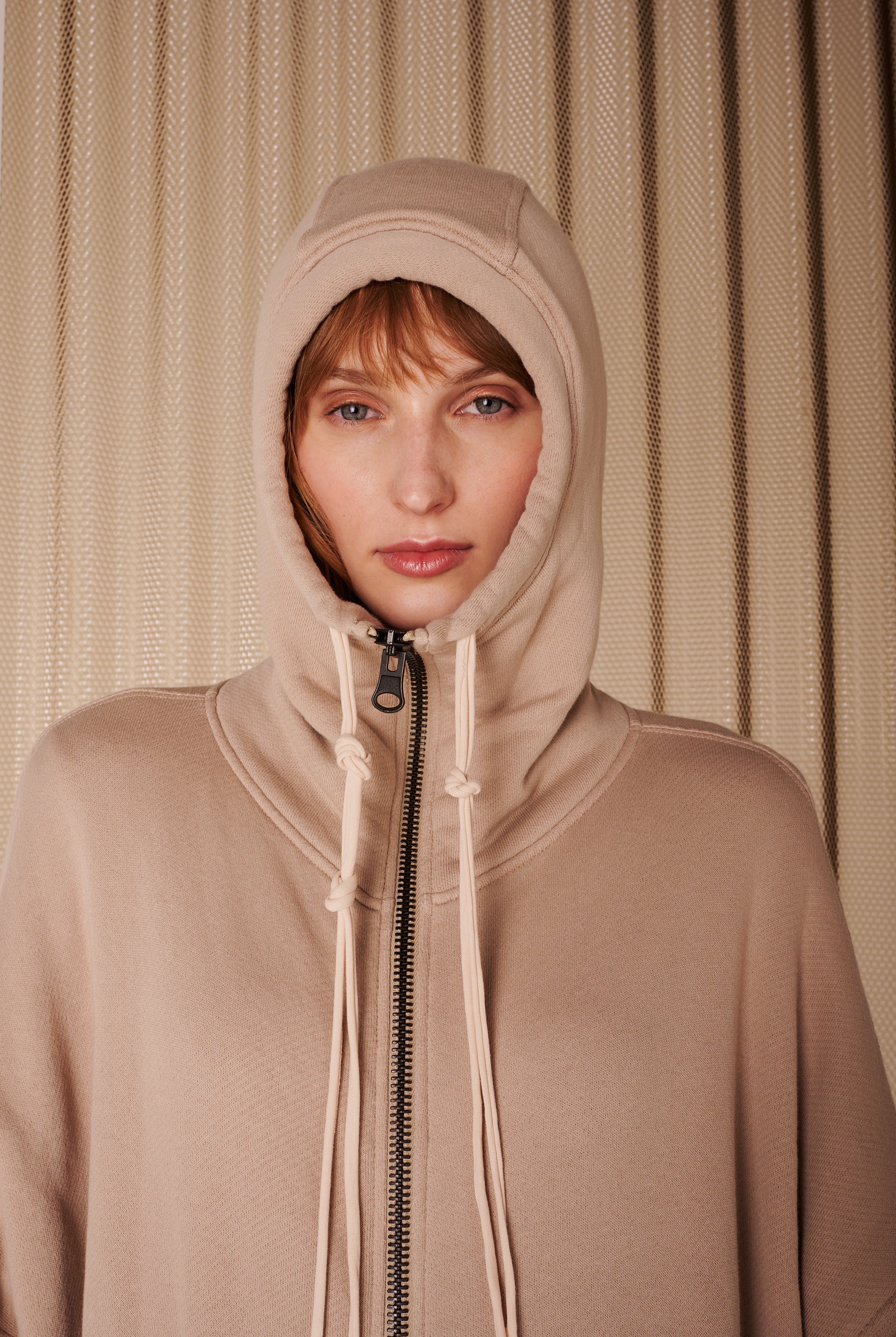 woman wearing a beige hoodie